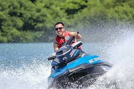 Happy Man Riding a Jet Ski on the Lake * Bass Lake Boat Rentals