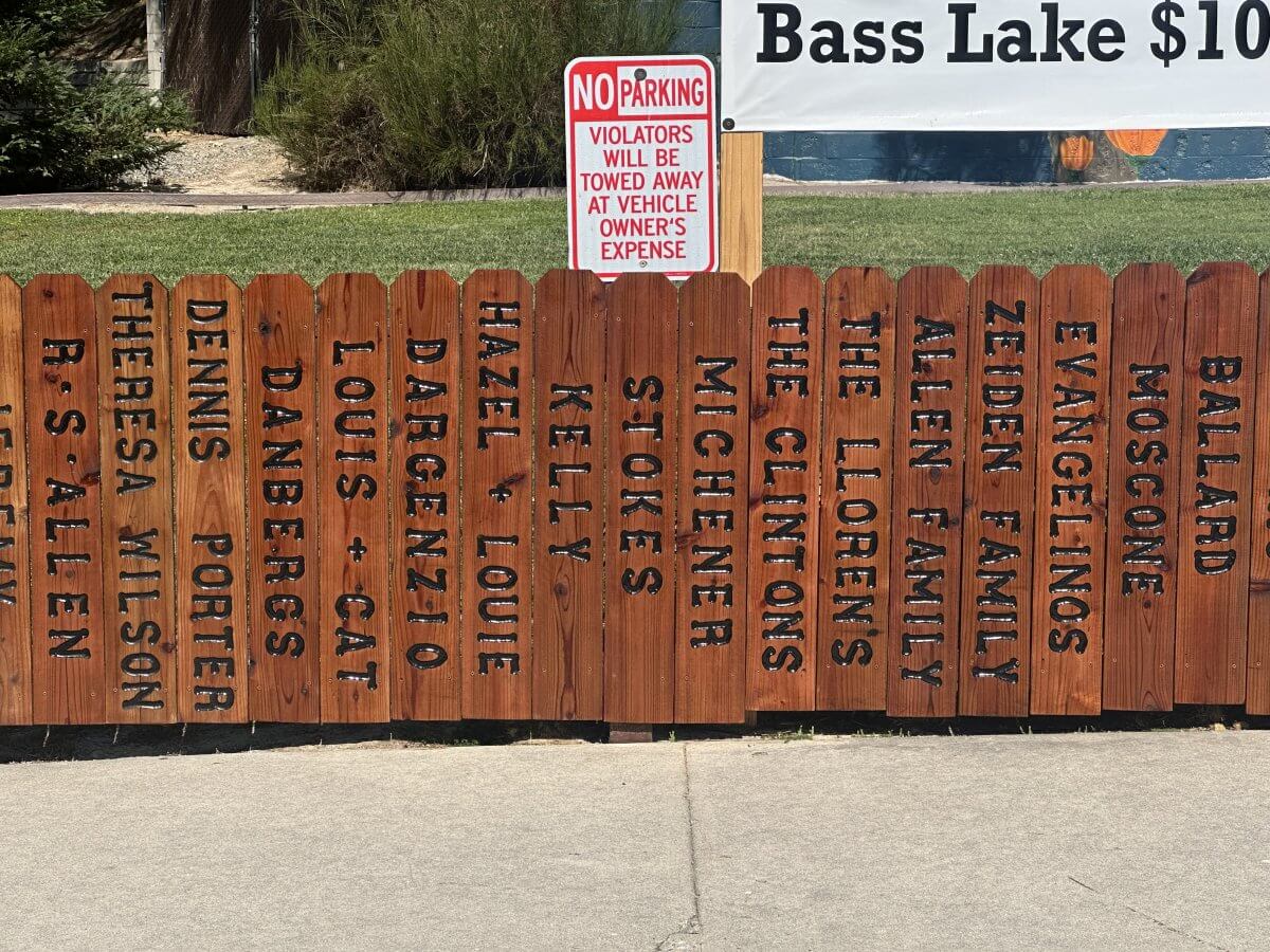 Bass Lake Memorial Fence Closeup Family Names on a Picket Fence
